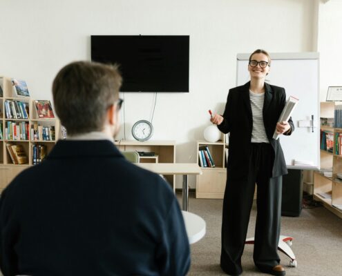 Confident certified life coach in modern office working with clients, representing 2025 life coach certification journey