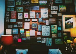 Vision board on a wall featuring images and words related to success, motivation, and personal growth—used by coaches for visualization and goal-setting.
