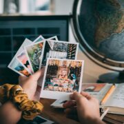 Client writing in a journal with photo memories nearby.