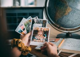 Client writing in a journal with photo memories nearby.