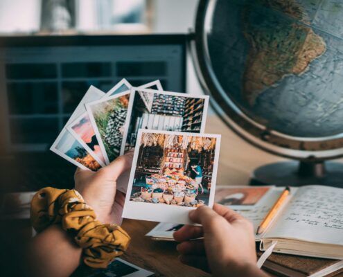 Client writing in a journal with photo memories nearby.