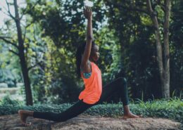 Woman practicing mindful movement in nature demonstrating somatic coaching techniques for body awareness and emotional release