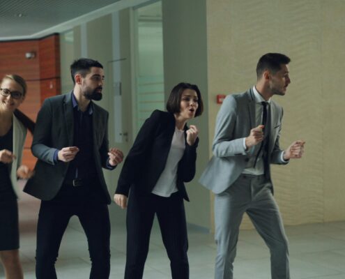 Corporate employees participating in a fun team activity promoting workplace wellness and engagement