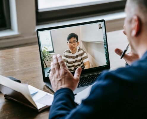 Online coaching discovery call with client and coach discussing goals over video meeting