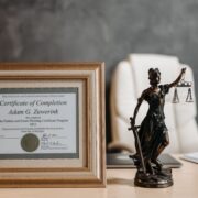 Framed life coach certification displayed in a professional office, representing coaching credentials and career development